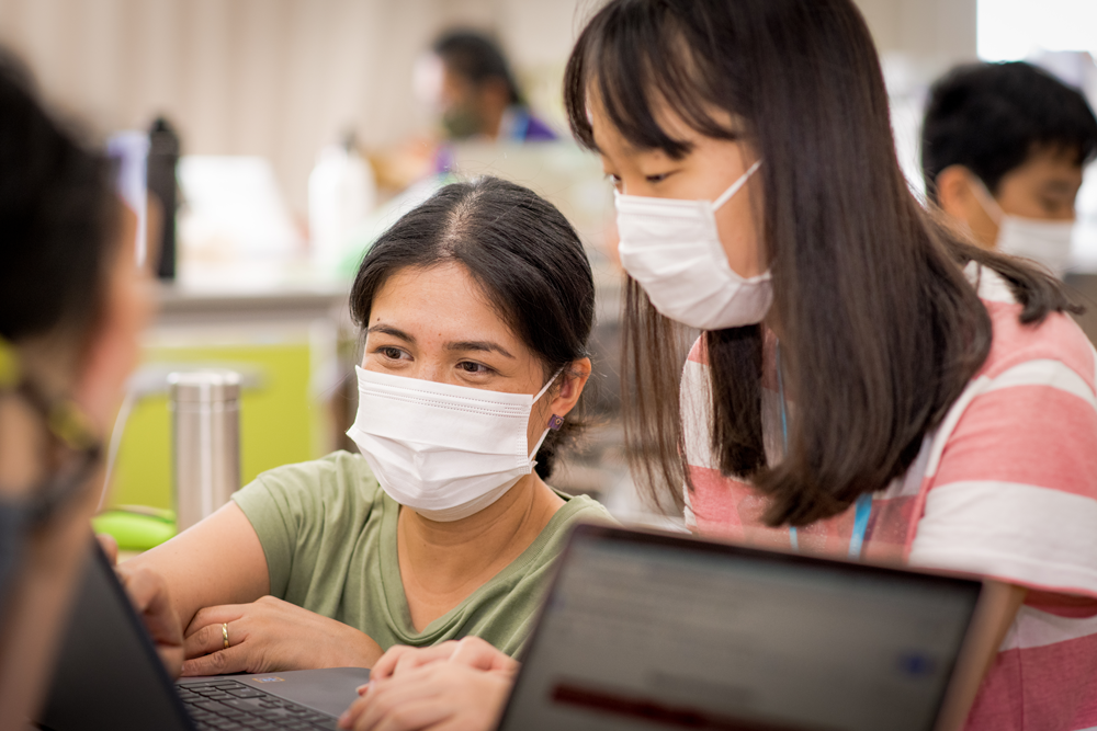 Teacher working with student